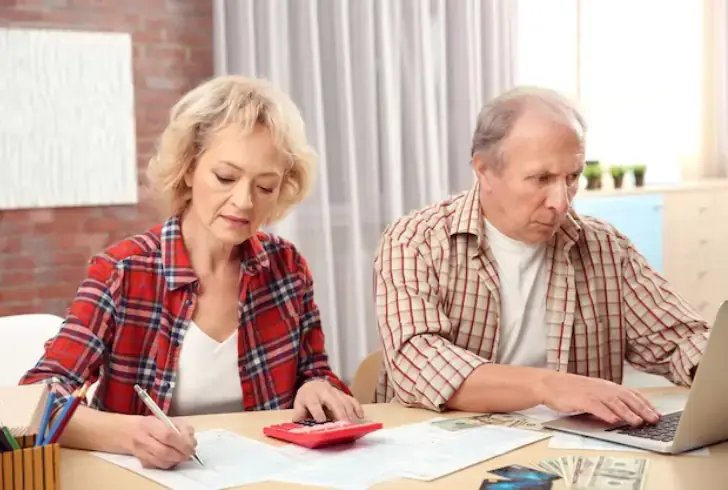 Senior reviewing money and documents